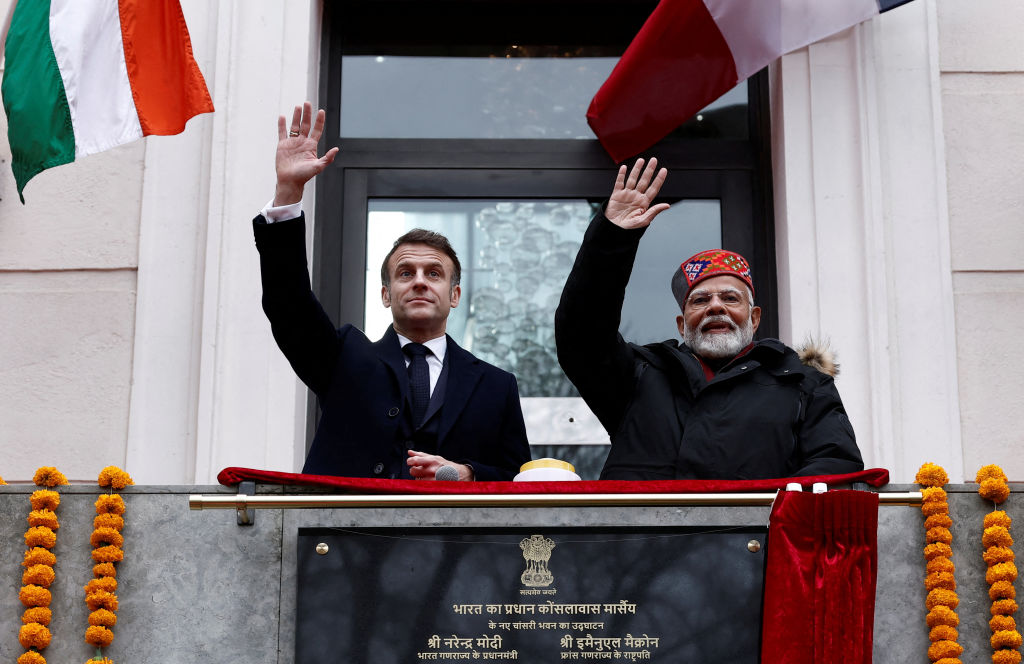 French President Emmanuel Macron and Indian Prime Minister Narendra Modi wave from the balcony during the inauguration of the Indian Consulate as part of a visit in Marseille, France, on February 12, 2025. (Photo by Christian Hartmann / POOL / AFP) (Photo by CHRISTIAN HARTMANN/POOL/AFP via Getty Images)