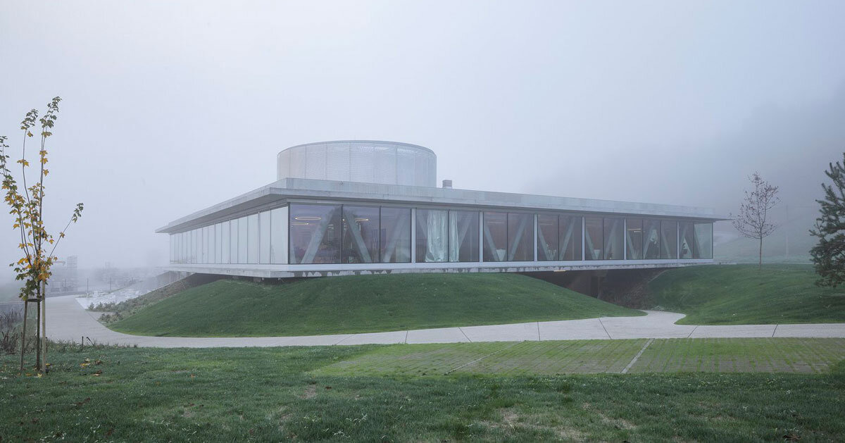 horizontal disk anchors office building by MVA on three greened mounds near zagreb