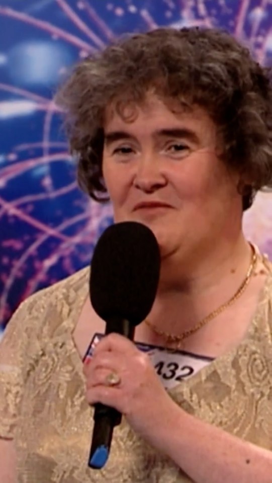 Susan Boyle holding a microphone during a singing audition.