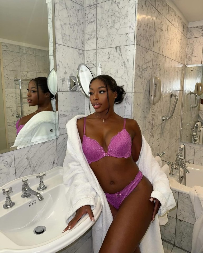 Woman in purple lingerie in a bathroom.