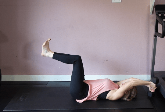 Woman performing a full-body workout exercise.