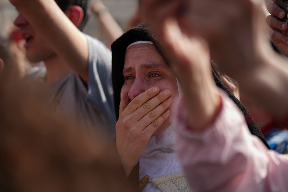 A nun cries at a funeral.