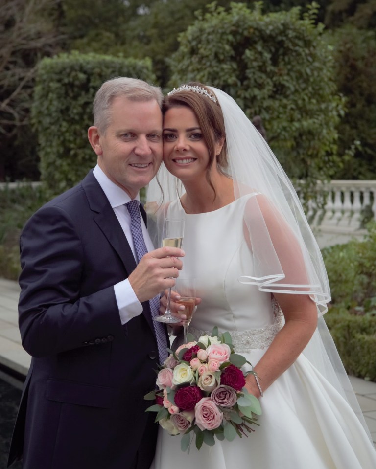 Jeremy Kyle and Vicky Burton on their wedding day, toasting with champagne.