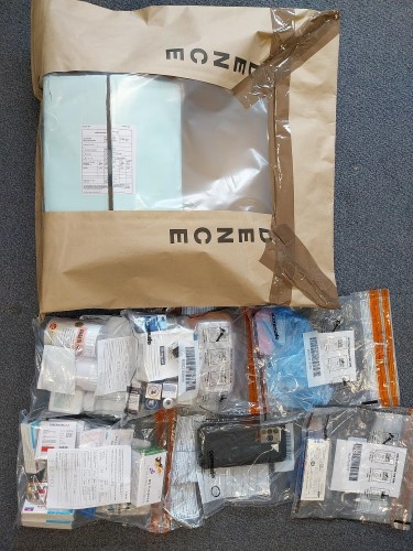 Seized drugs and phone in plastic bags.