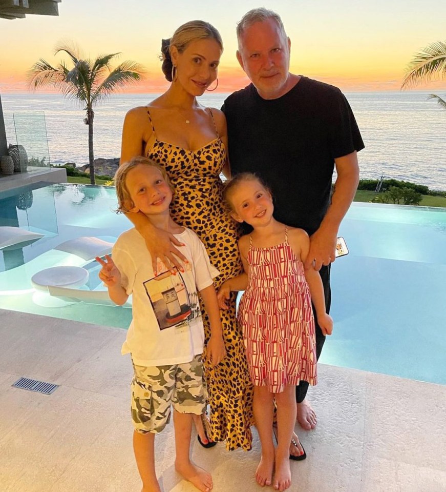 Family photo by a pool at sunset.