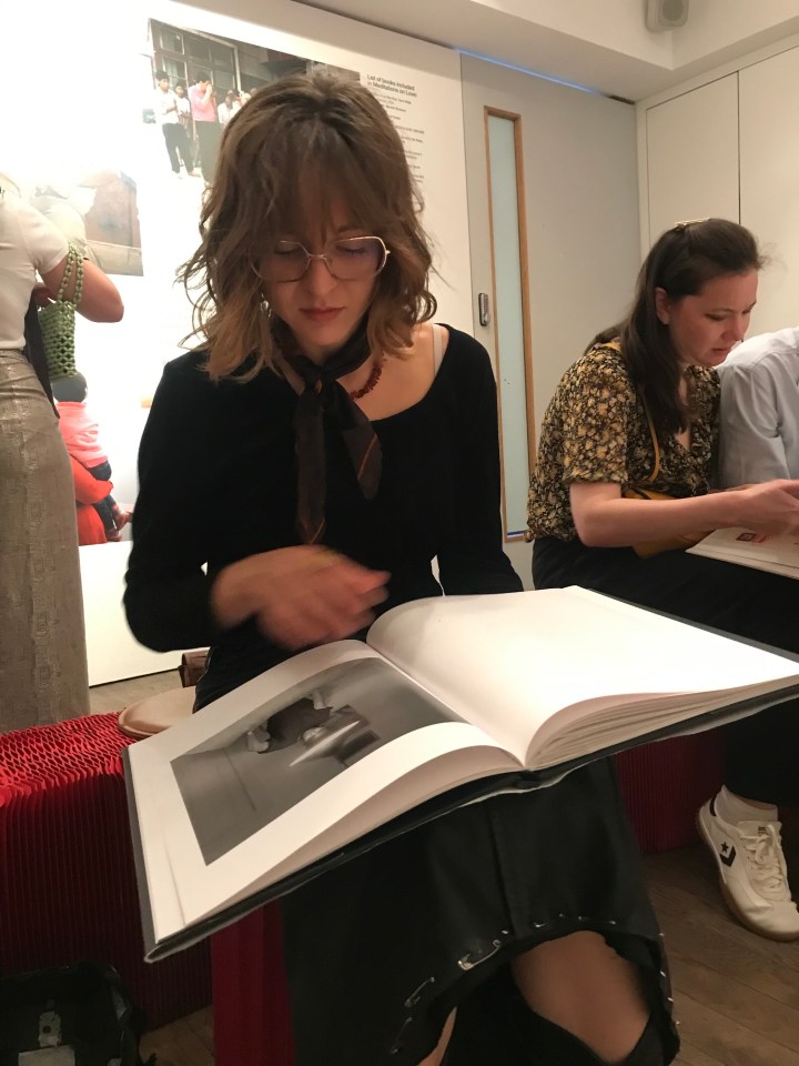 Woman looking at a large book.