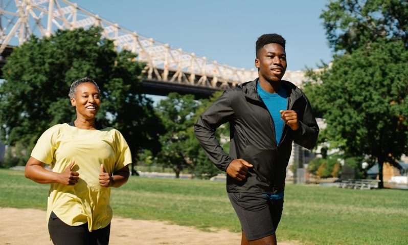 Man running with woman outdoors