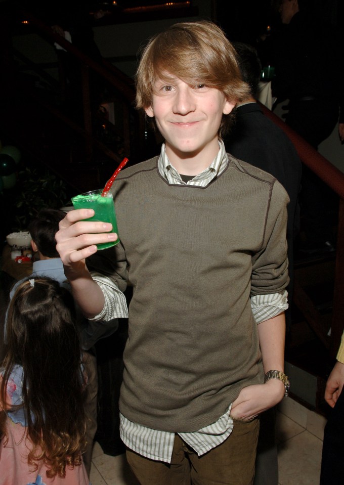 Erik Per Sullivan holding a green drink.
