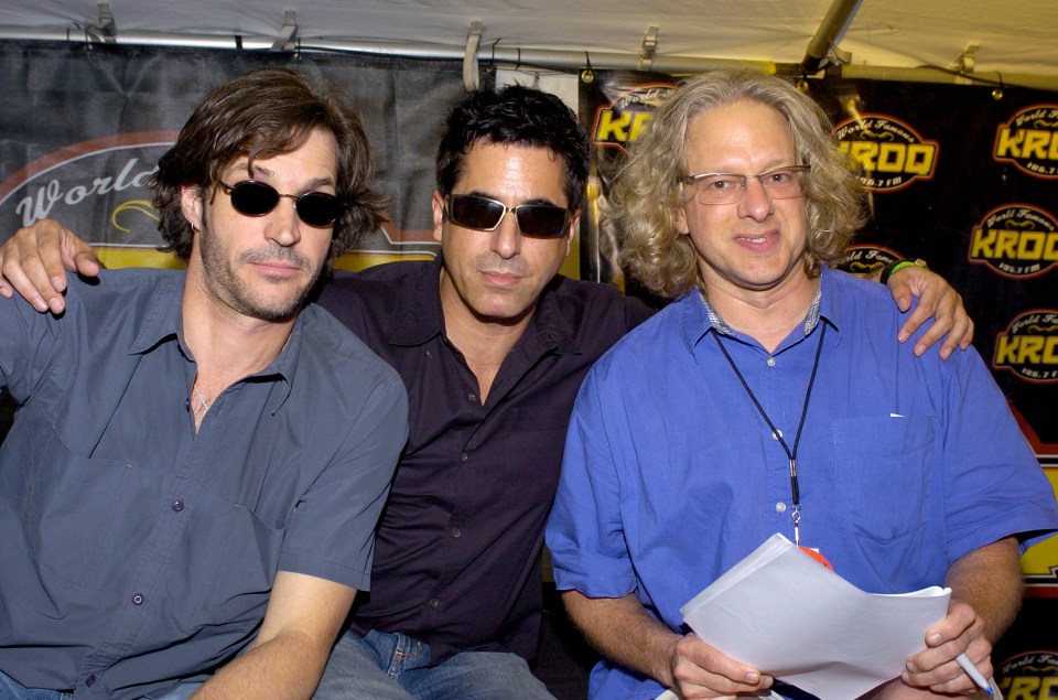Three men posing for a photo.
