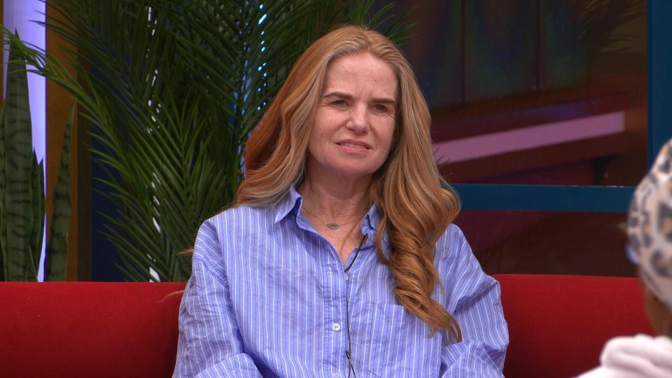 Patsy from Celebrity Big Brother on a red sofa.