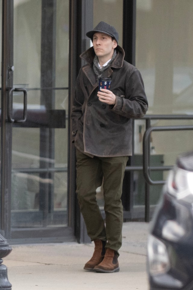 Erik Per Sullivan leaving his house with a coffee.