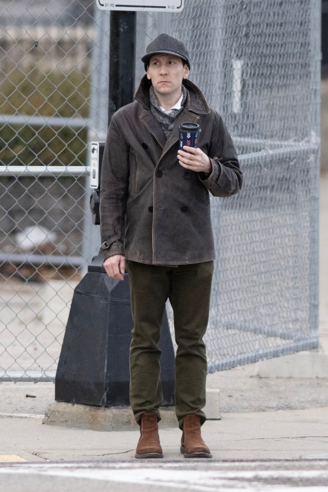 Erik Per Sullivan holding a coffee cup.