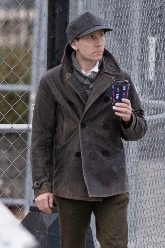 Erik Per Sullivan leaving his house with a coffee.