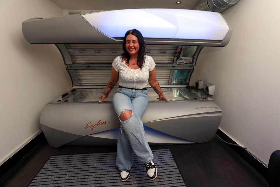 Woman sitting on a tanning bed.