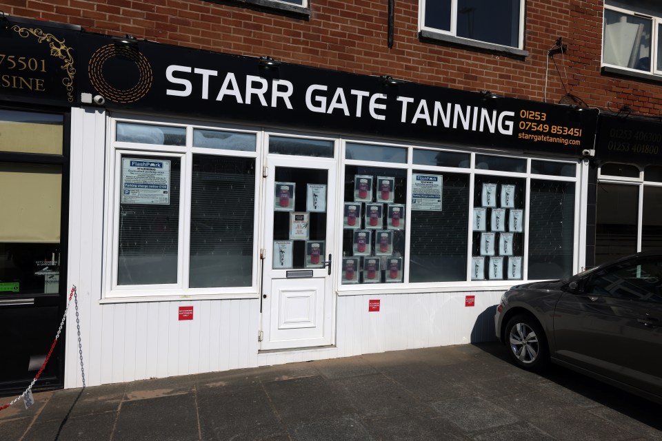 Woman standing outside Starr Gate Tanning salon in Blackpool.