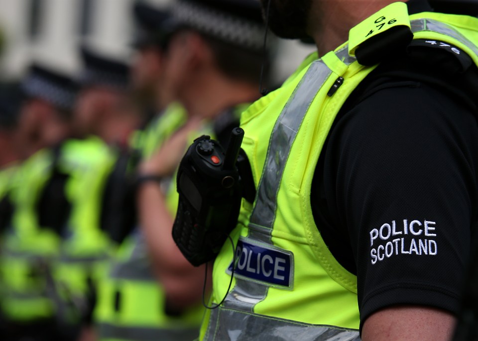 Close-up of Police Scotland officers at a demonstration.