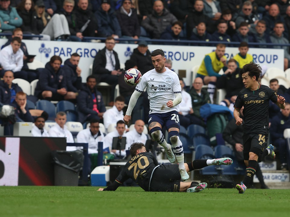 Soccer player leaping over another player during a game.