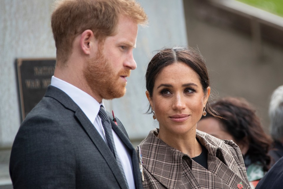 Prince Harry and Meghan Markle laying a wreath.