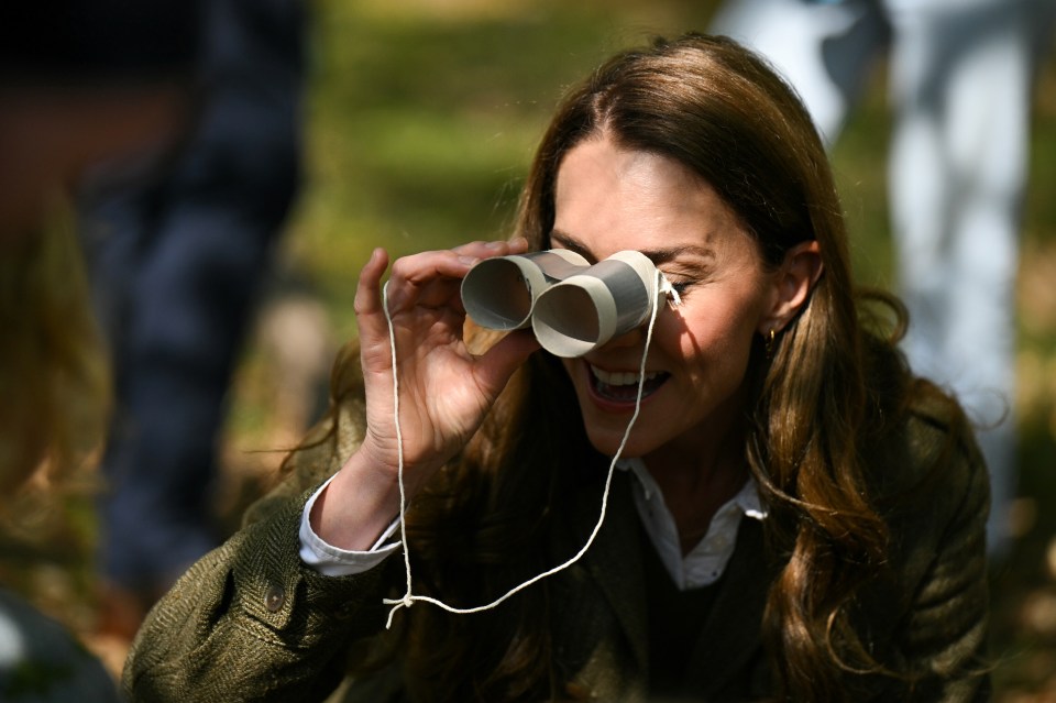 The Princess of Wales using cardboard binoculars.