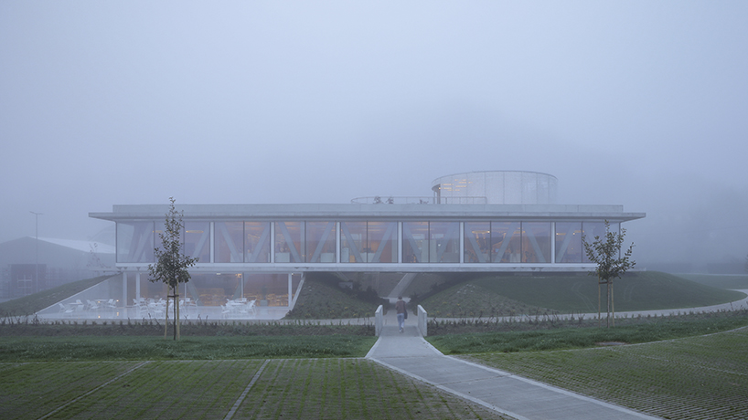 horizontal disk anchors office building by MVA on three greened mounds near zagreb