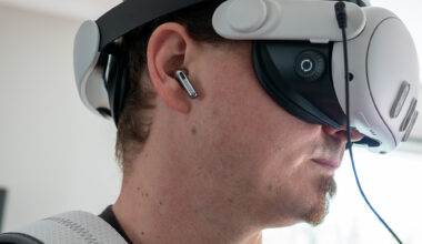 A Meta Quest 3 hooked up to a Woojer Haptic Vest 3 while wearing OnePlus Buds 3