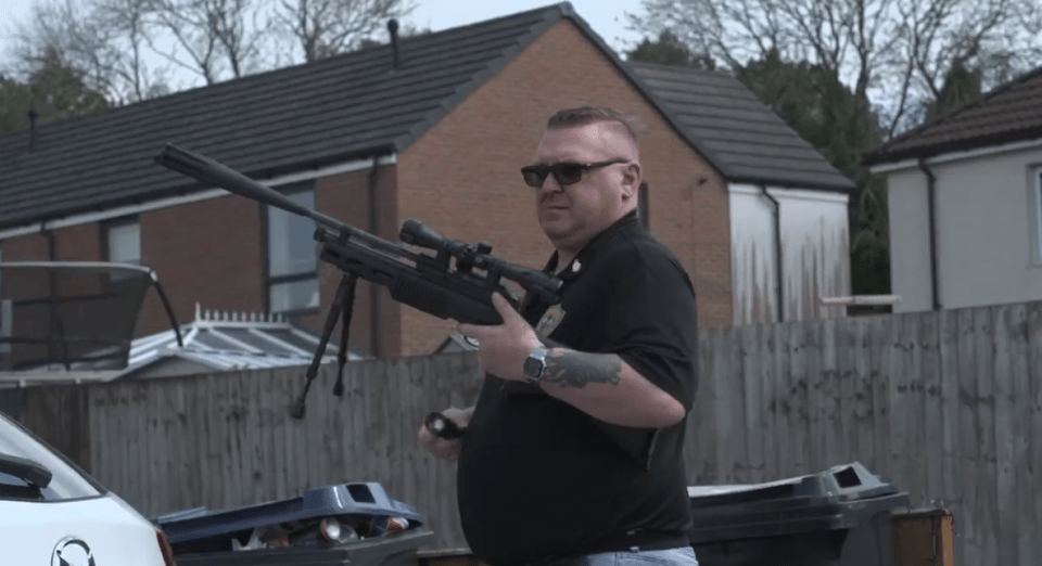 Rat catcher holding an air rifle.