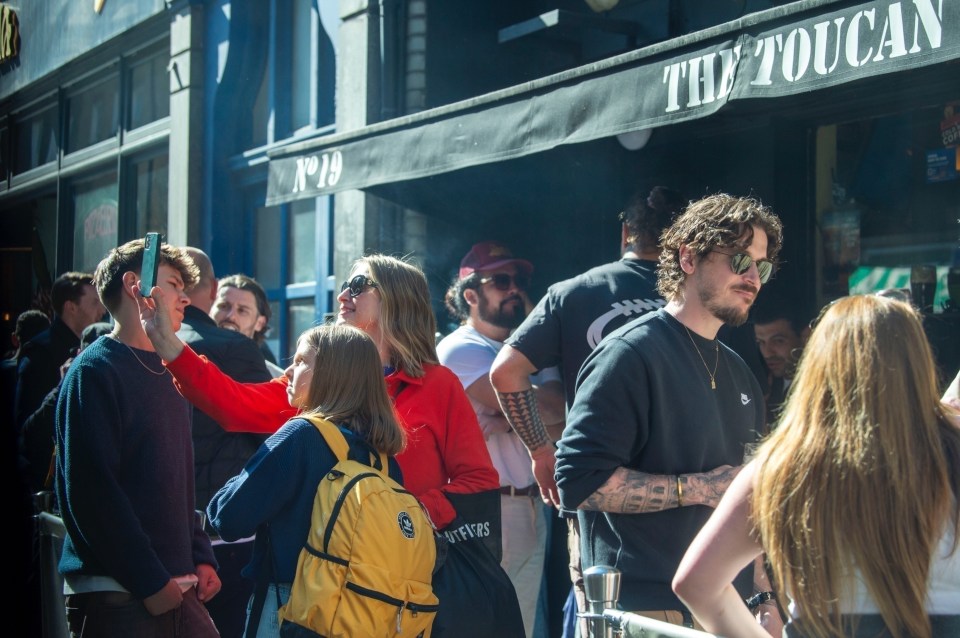 Jason Momoa in London, surrounded by people.