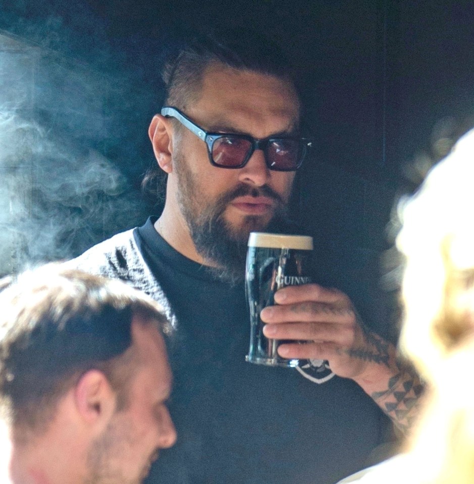 Jason Momoa drinking a pint of Guinness in London.