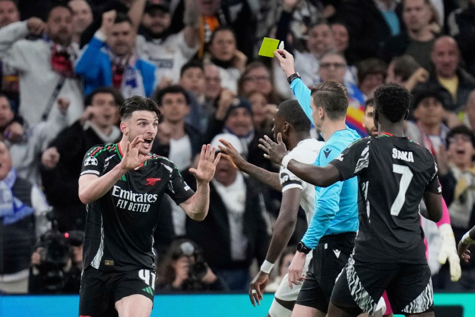 Referee showing Declan Rice a yellow card.
