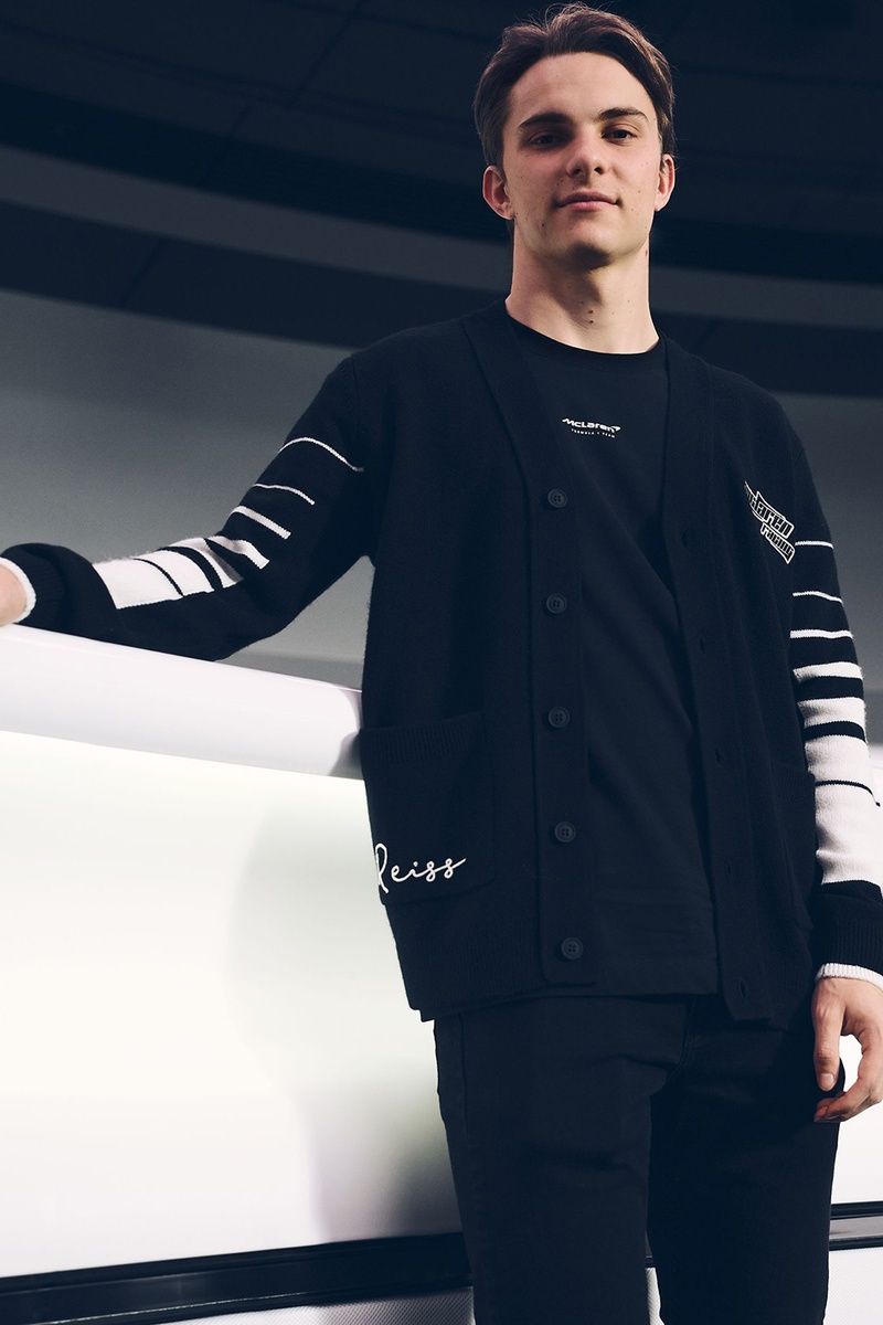 Oscar Piastri wears a Reiss cardigan from the brand's second collaboration with McLaren