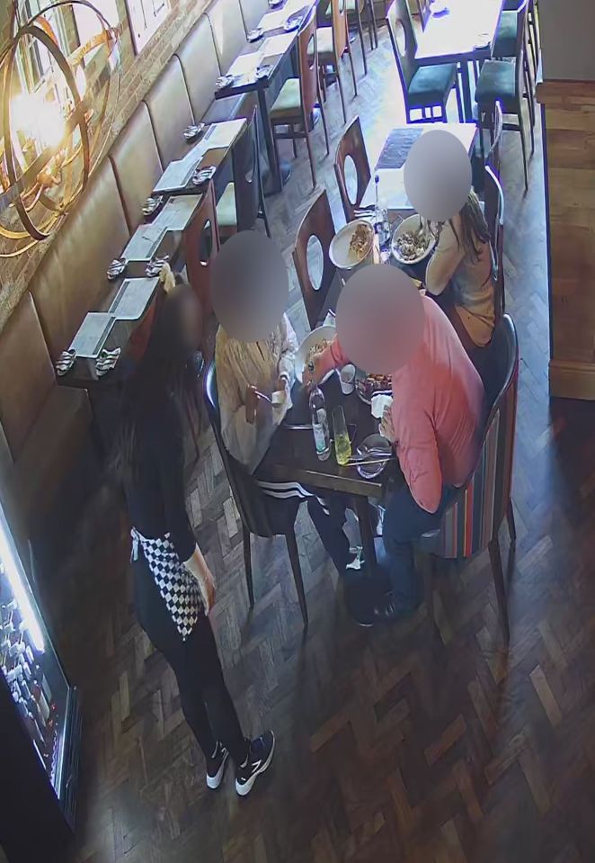 CCTV footage of a restaurant showing a couple and a child appearing to plant glass in their food.