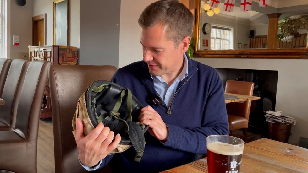 Robert Jenrick holding Lee's helmet