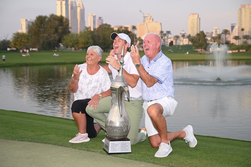 Rory McIlroy with his parents and the Hero Dubai Desert Classic trophy.