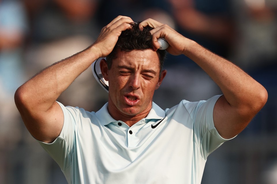 Rory McIlroy reacting after finishing a golf hole.