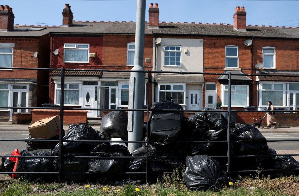 Pile of garbage bags on a street during a bin workers' strike.