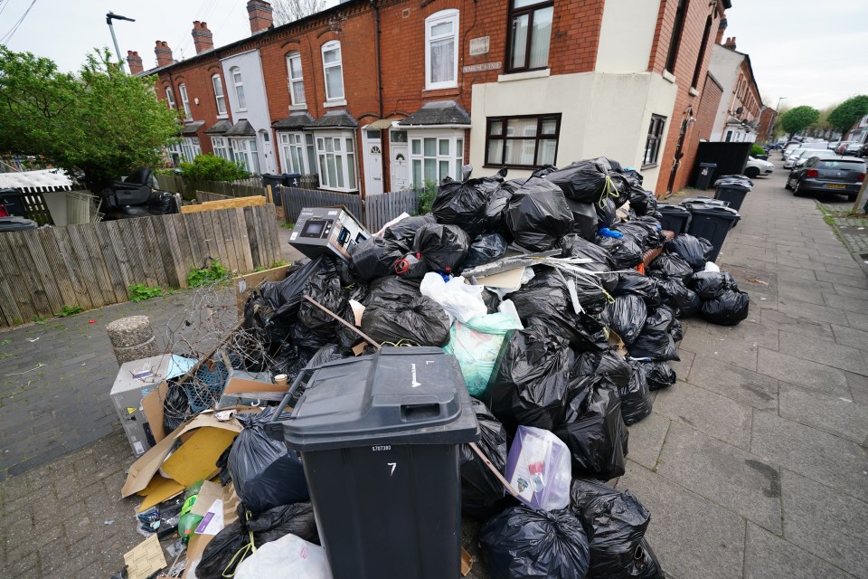 Pile of rubbish bags on a residential street during a refuse collectors' strike.