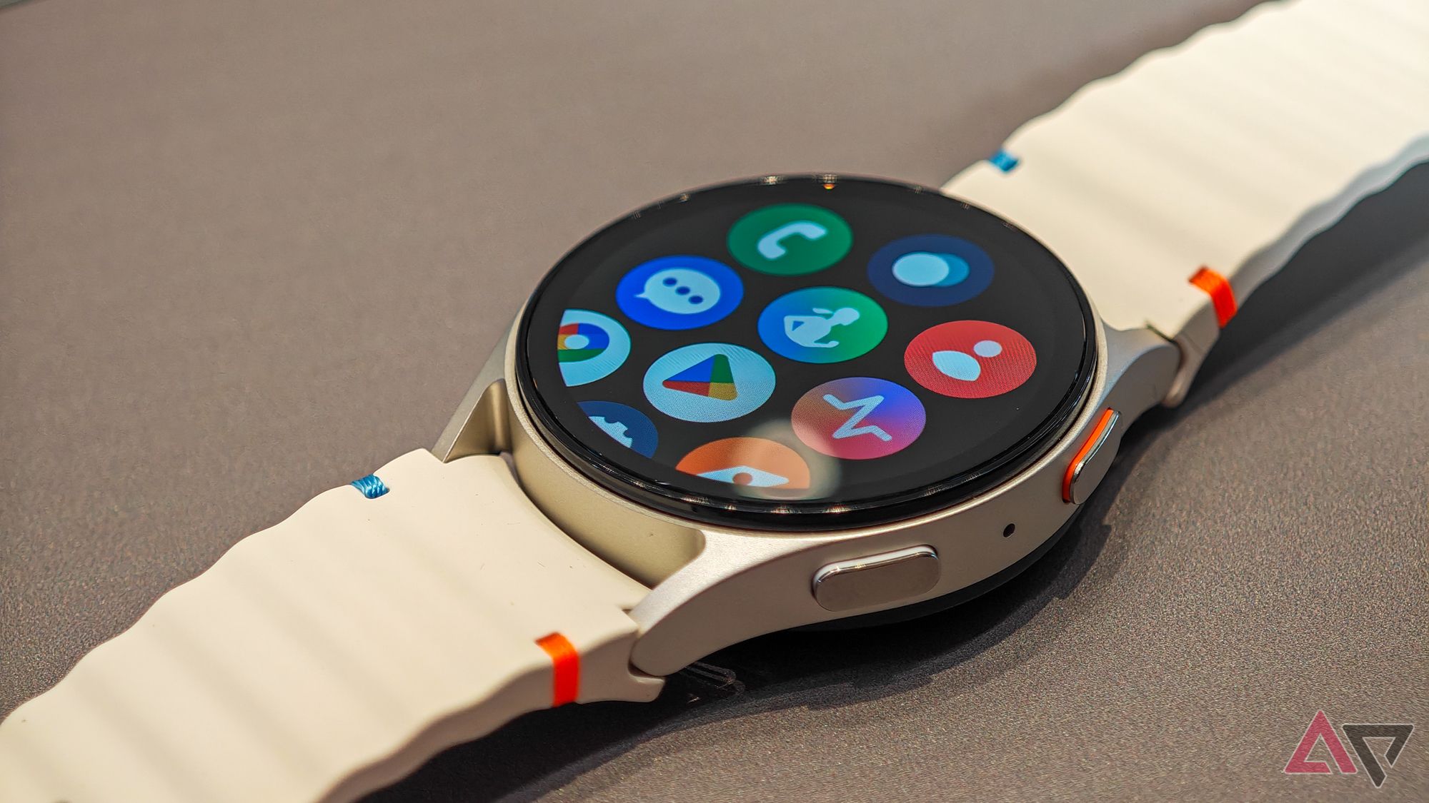 Samsung Galaxy Watch 7 in white on a dark flat surface