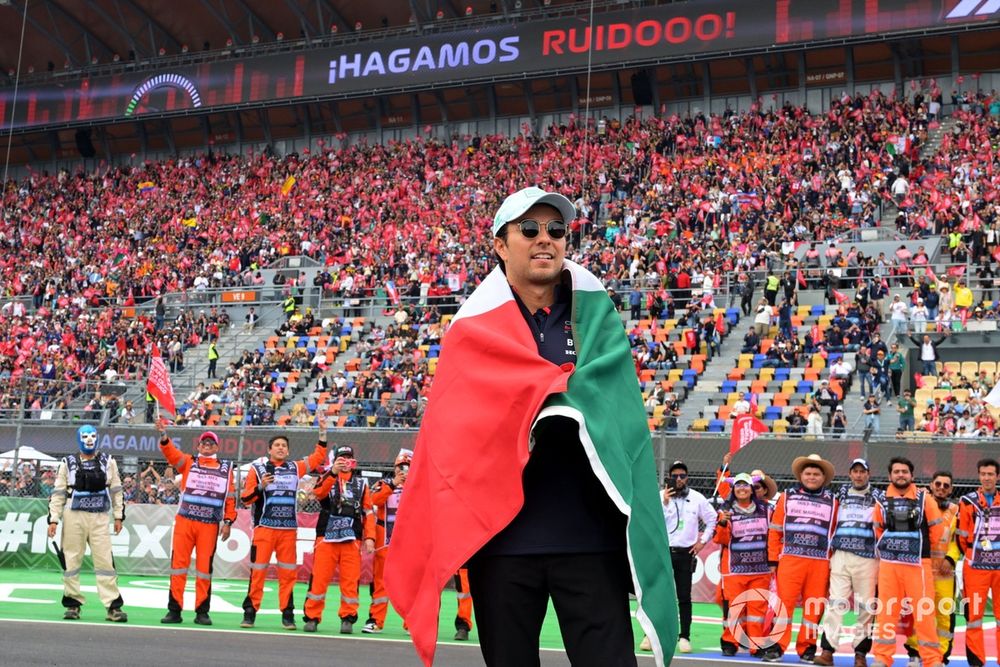Sergio Perez, Red Bull Racing, holds up the Mexican flag