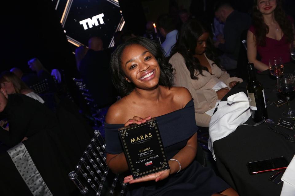 Woman holding award for Jewellery Store of the Year.