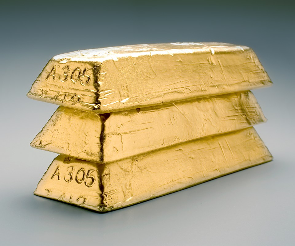 Stack of three gold bars.