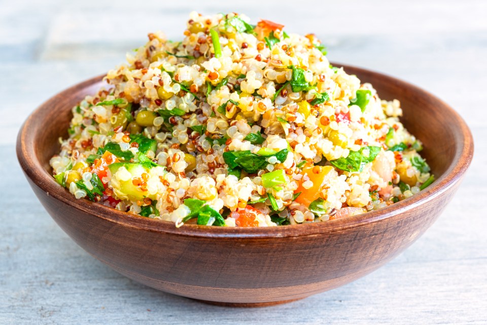 Mixed quinoa salad in a wooden bowl.