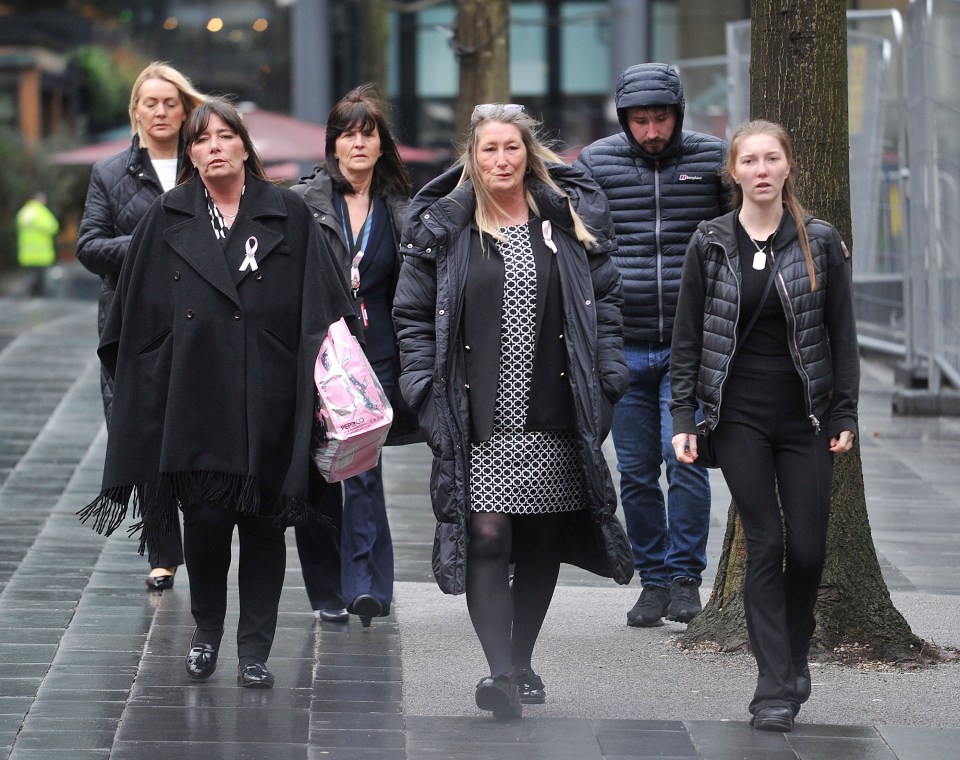 Family members walking outside a courthouse.