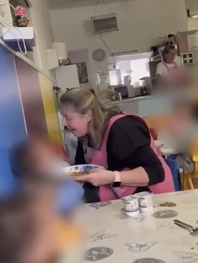 Screenshot of a woman appearing distressed while holding a plate of food in a nursery setting.