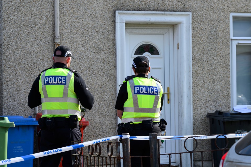 Two police officers at a crime scene.