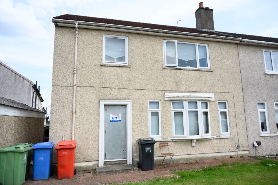 House with boarded-up front door following a stabbing incident.