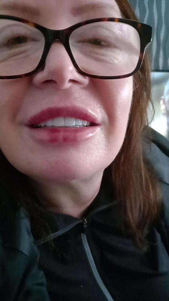 Close-up of a woman wearing glasses.