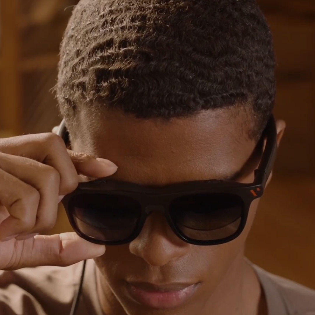 Man adjusts myopia sliders on Viture Pro XR glasses.