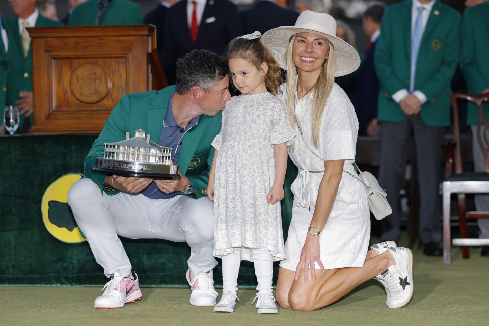Rory McIlroy with his family and the Masters Tournament trophy.