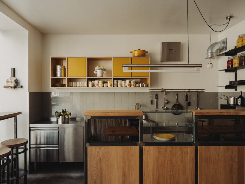 wiercinski-studio builds cozy 'amator' restaurant around modular oak table in copenhagen