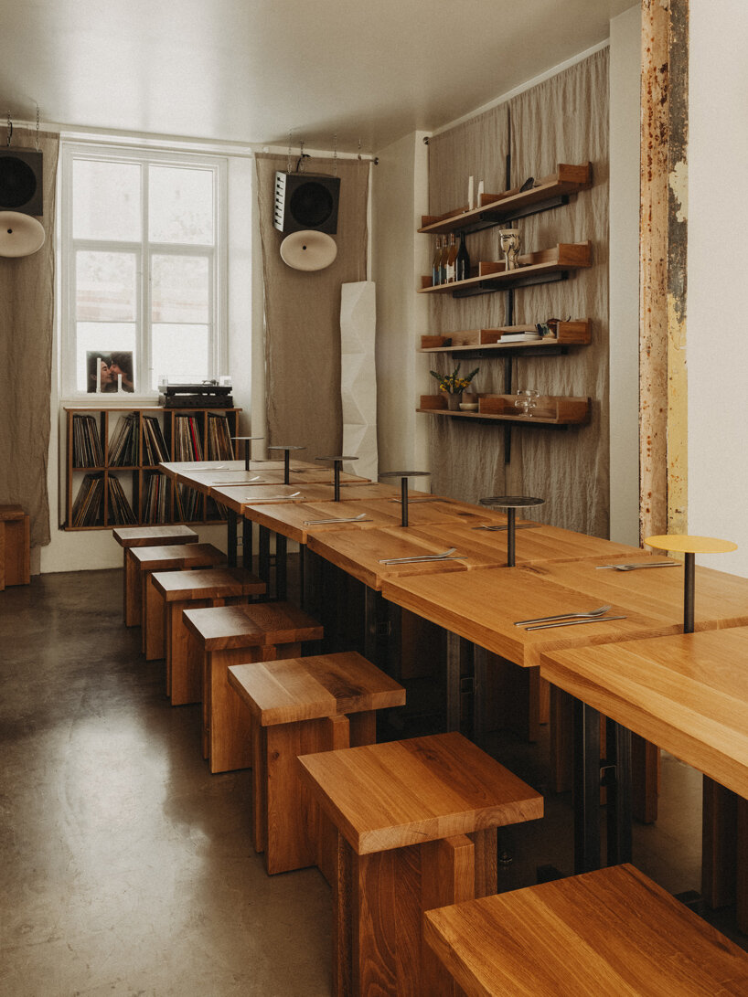 wiercinski-studio builds cozy 'amator' restaurant around modular oak table in copenhagen